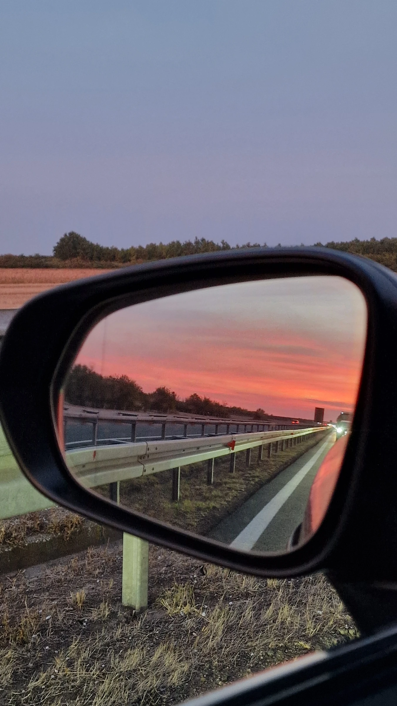 Sunset reflected in the car mirror