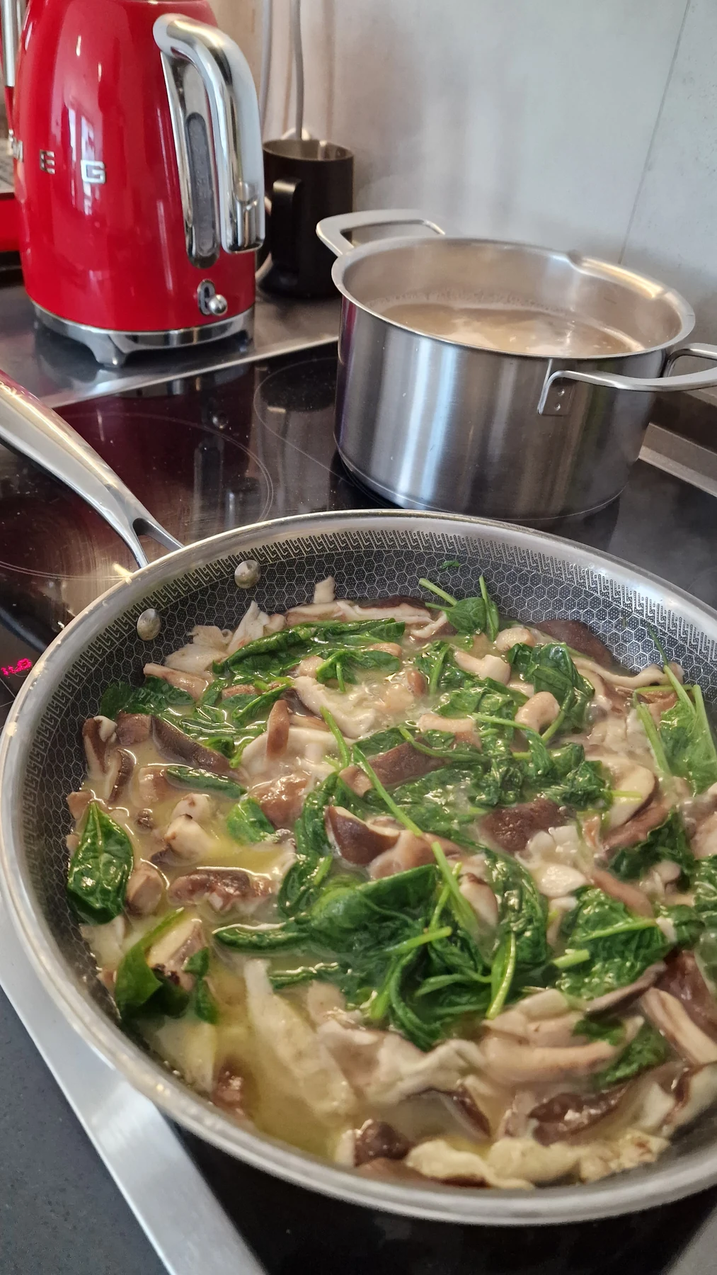 Oyster mushrooms and spinach simmering in cream before adding the pappardelle